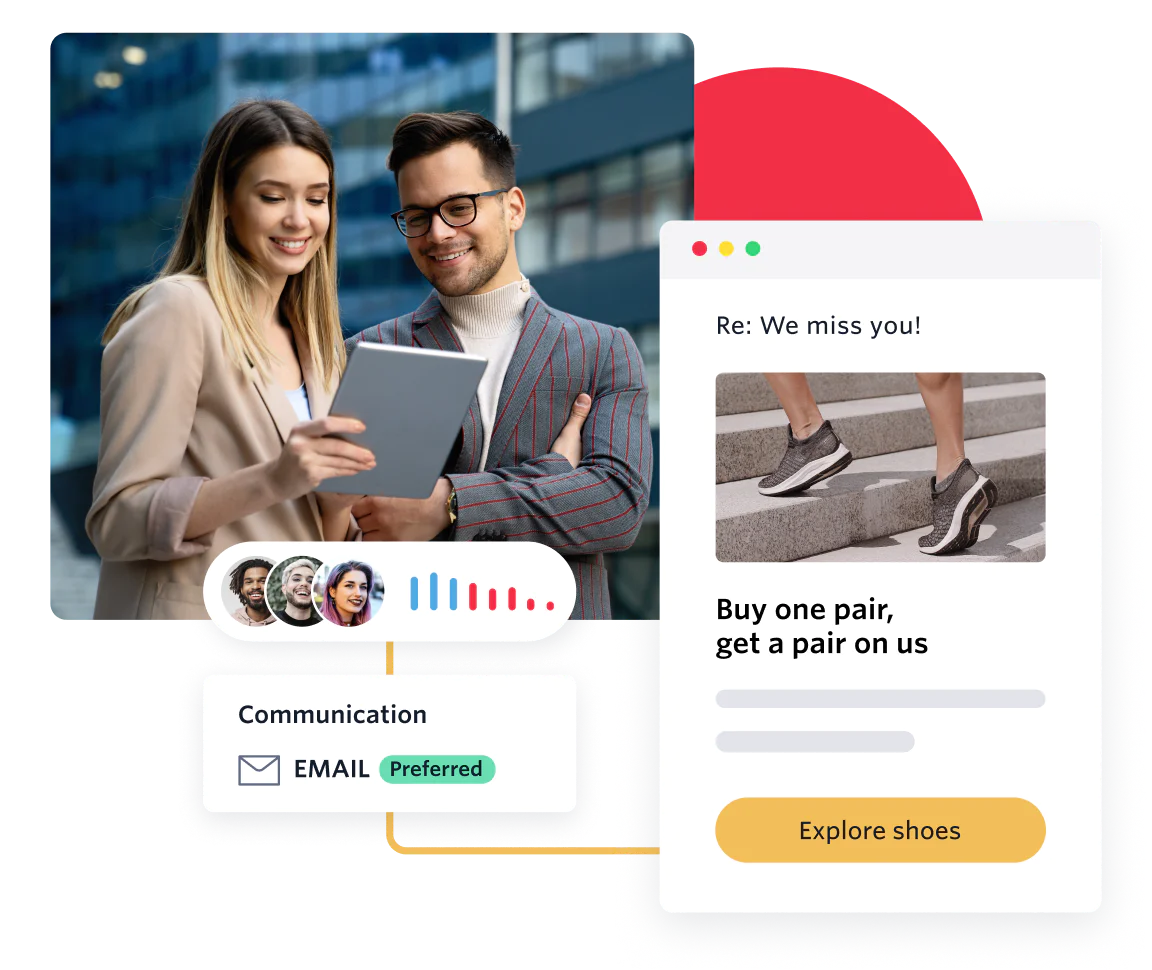 Two people reviewing marketing materials with an email campaign displayed on screen.