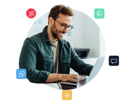 Man working on a laptop surrounded by communication icons Smiling man using a laptop, surrounded by communication icons including chat, WhatsApp, and voice.
